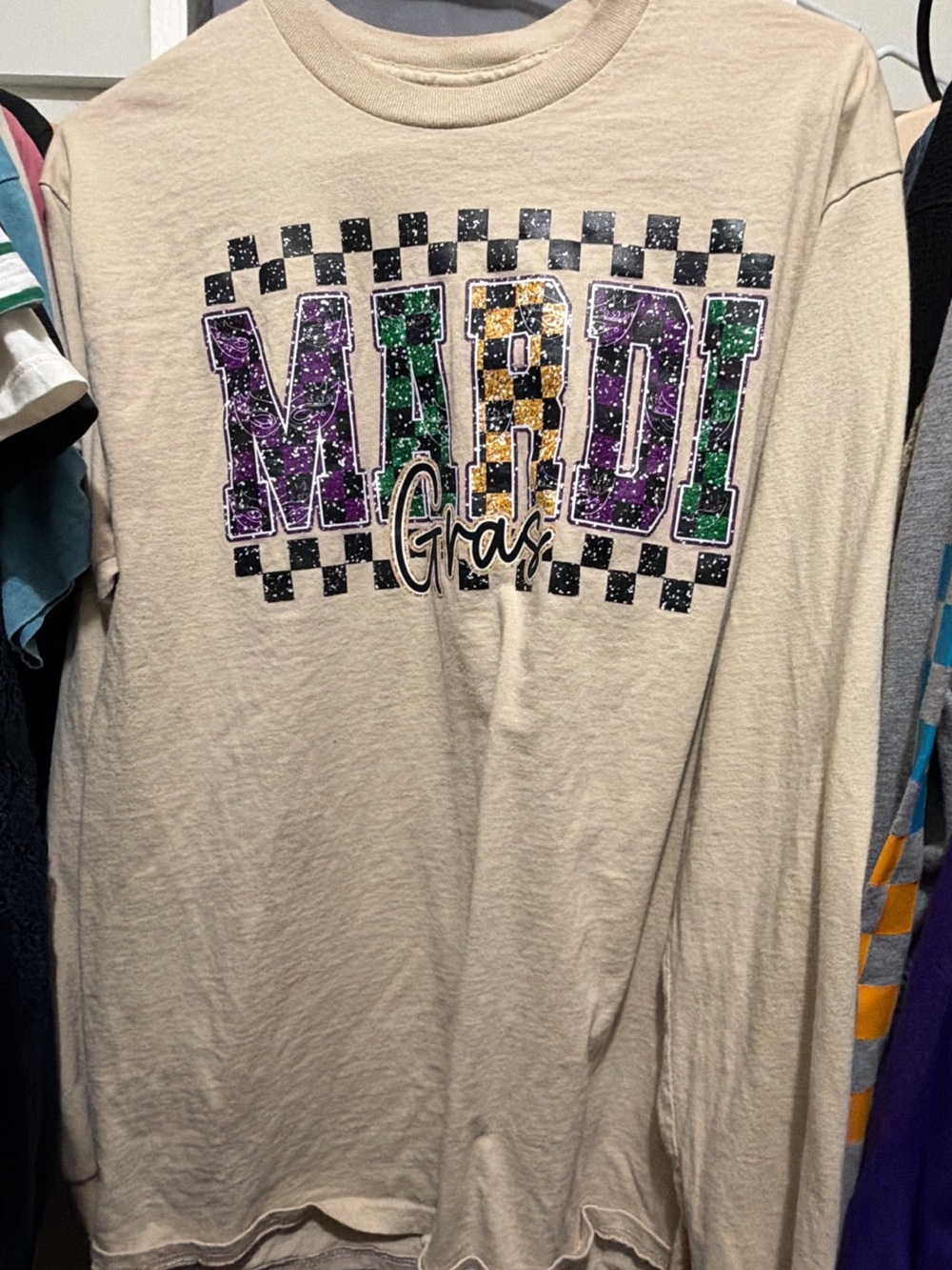 Gildan Beige Long Sleeve Mardi Gras Graphic Tee with Purple Green Gold Print